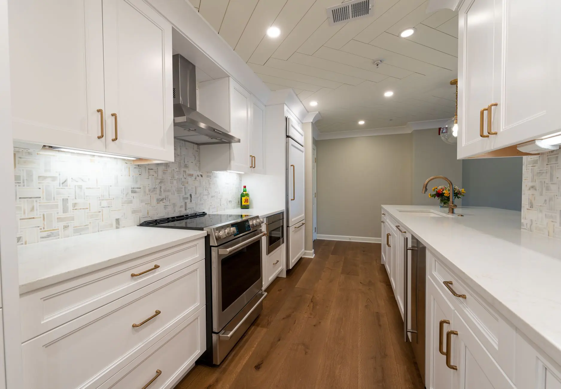 Modern kitchen with white cabinetry and stainless steel appliances