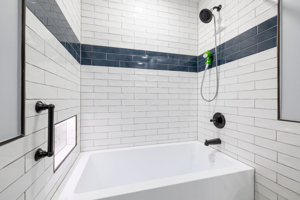 Sleek, minimalist bathroom with white and blue tiles and contemporary fixtures.