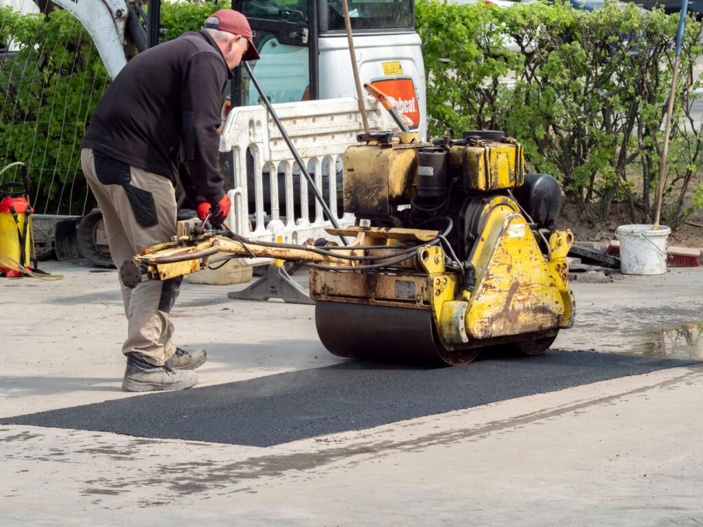 Close-up of a construction worker operating machinery in Wrocław, Poland, repairing the street.