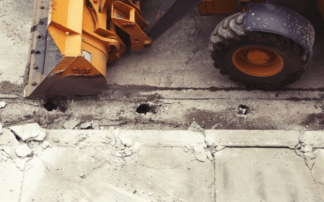 Close-up of an excavator working on road construction, showcasing the industrial process.
