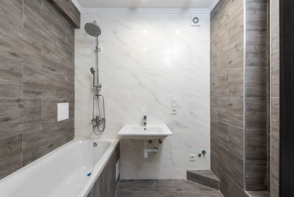Elegant modern bathroom interior with wooden details and sleek design.