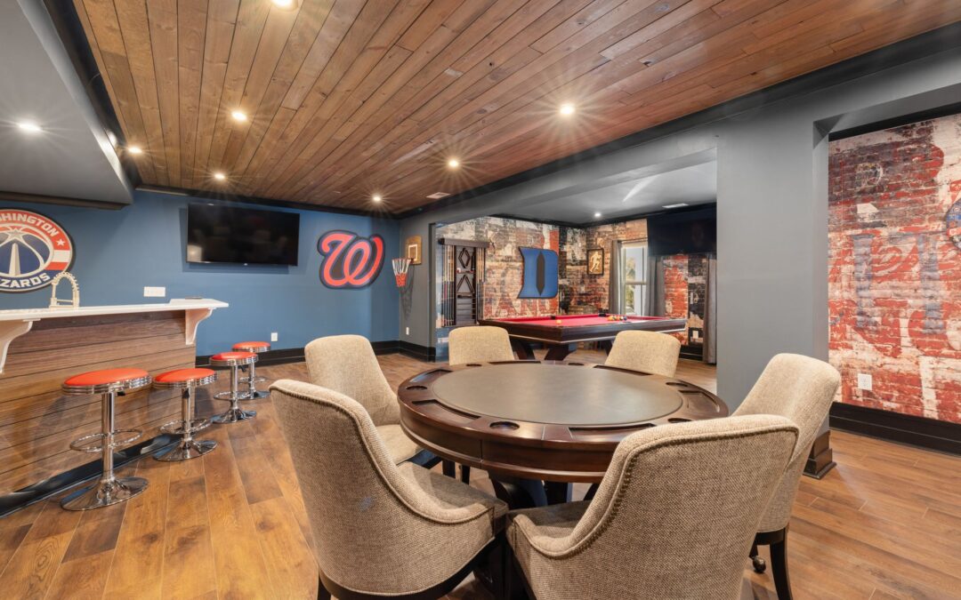 Modern basement game room with bar, seating, and pool table.