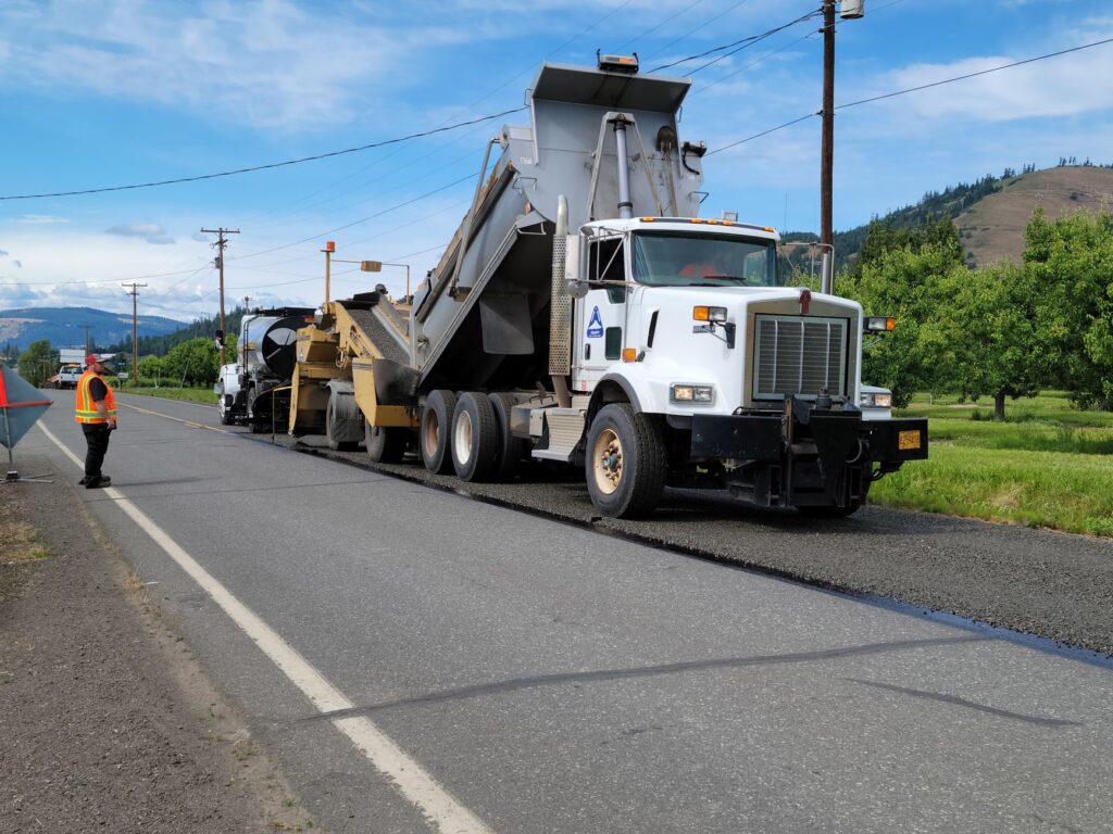 Paving equipment and crew working on road construction in Hood River, Oregon.
