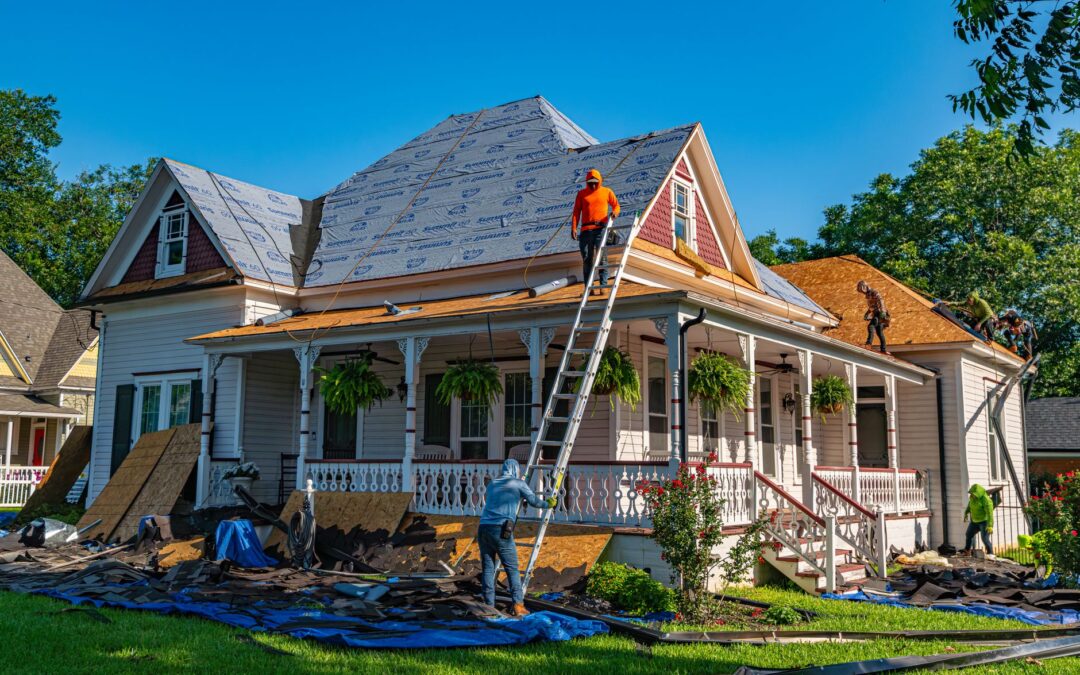 Roofers replace the roof of a historic home in Weatherford, Texas.