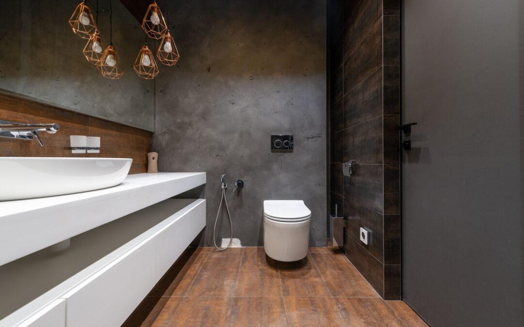 Sleek modern bathroom featuring a minimalist sink and elegant hanging lights.
