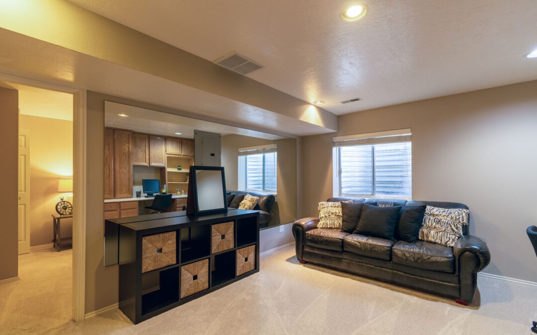 Warm and inviting basement living room featuring a leather sofa and modern decor.