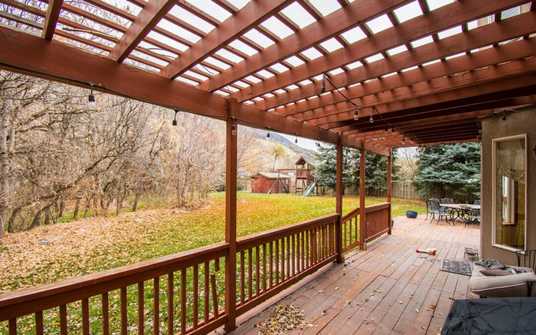 A beautiful wooden deck with autumn leaves, perfect for relaxing outdoors.