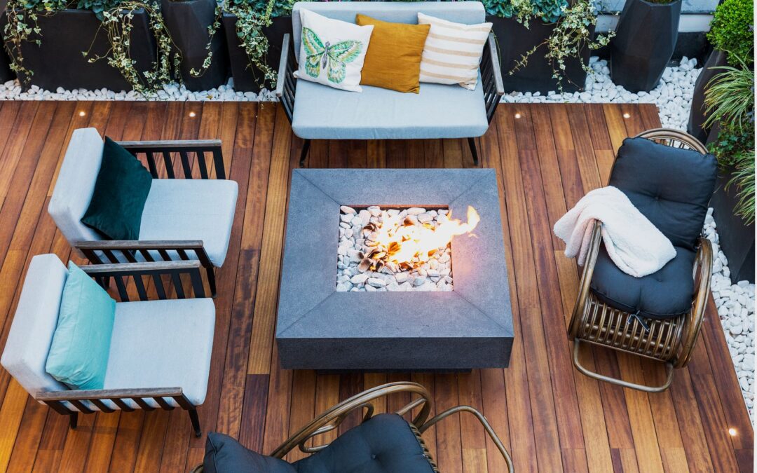A top-down view of a modern patio featuring stylish furniture and a central firepit.