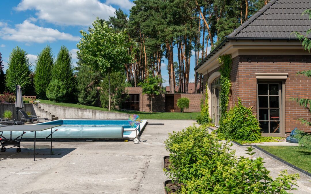 Beautiful suburban house with a private pool and lush greenery, perfect for summer relaxation.
