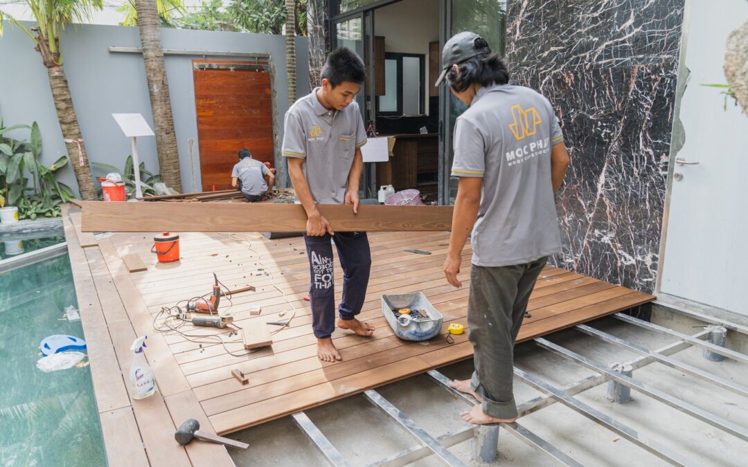Carpenters working on a wooden floor installation in Hồ Chí Minh, Việt Nam.