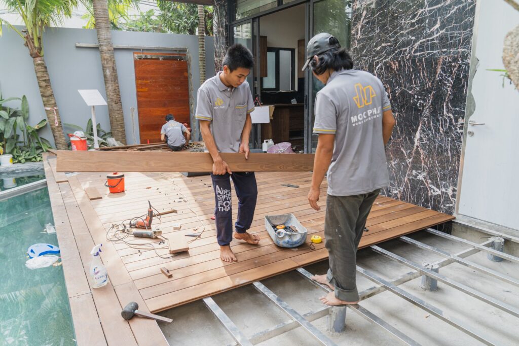 Carpenters working on a wooden floor installation in Hồ Chí Minh, Việt Nam.