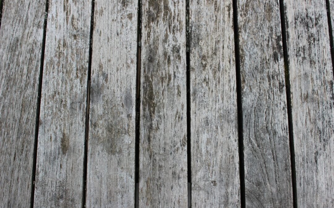 Close-up of weathered wooden planks with visible grain and texture, ideal for design backgrounds.