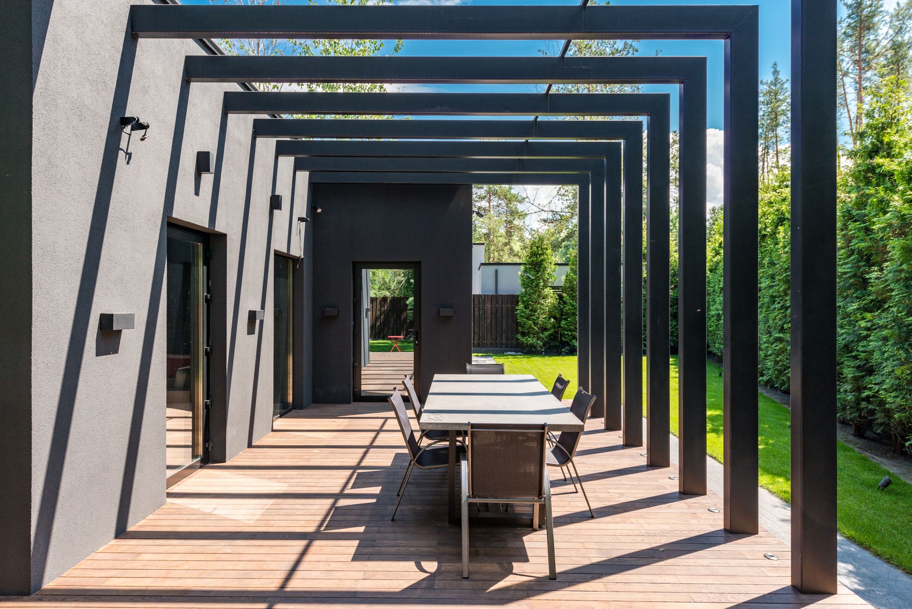 Outdoor living space with a deck cover / pergola over dining area