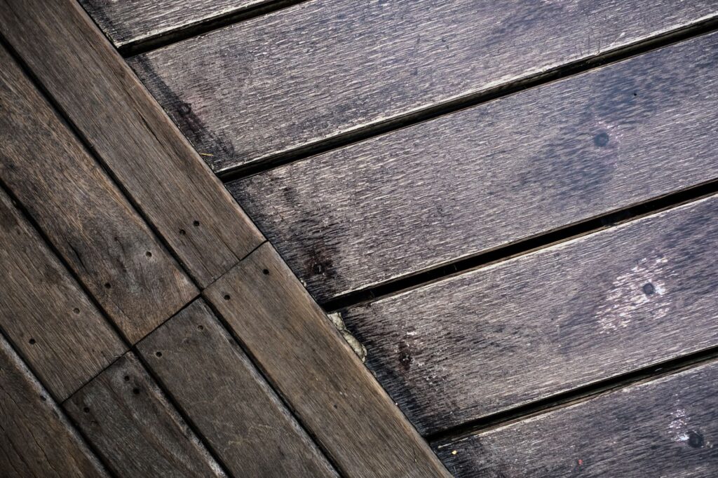 Detailed close-up of a rustic wooden floor showing rich grain patterns and natural wear.
