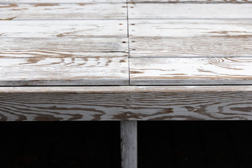 Detailed view of aged wooden planks, showing texture and screws for rustic design ideas.