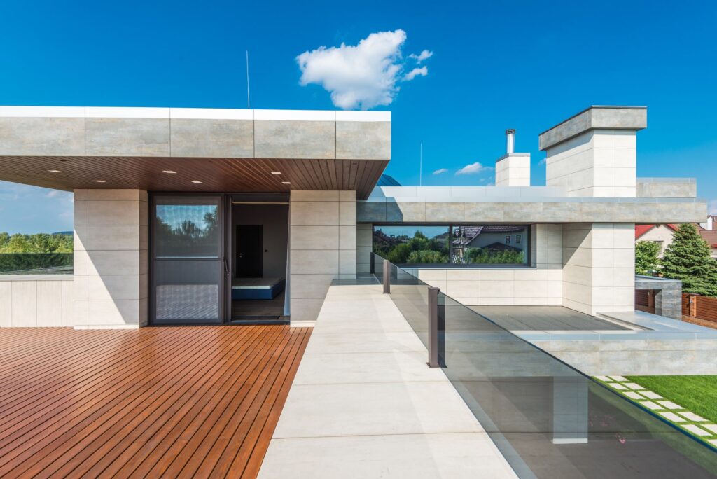Sleek modern terrace featuring wood decking and blue sky background.