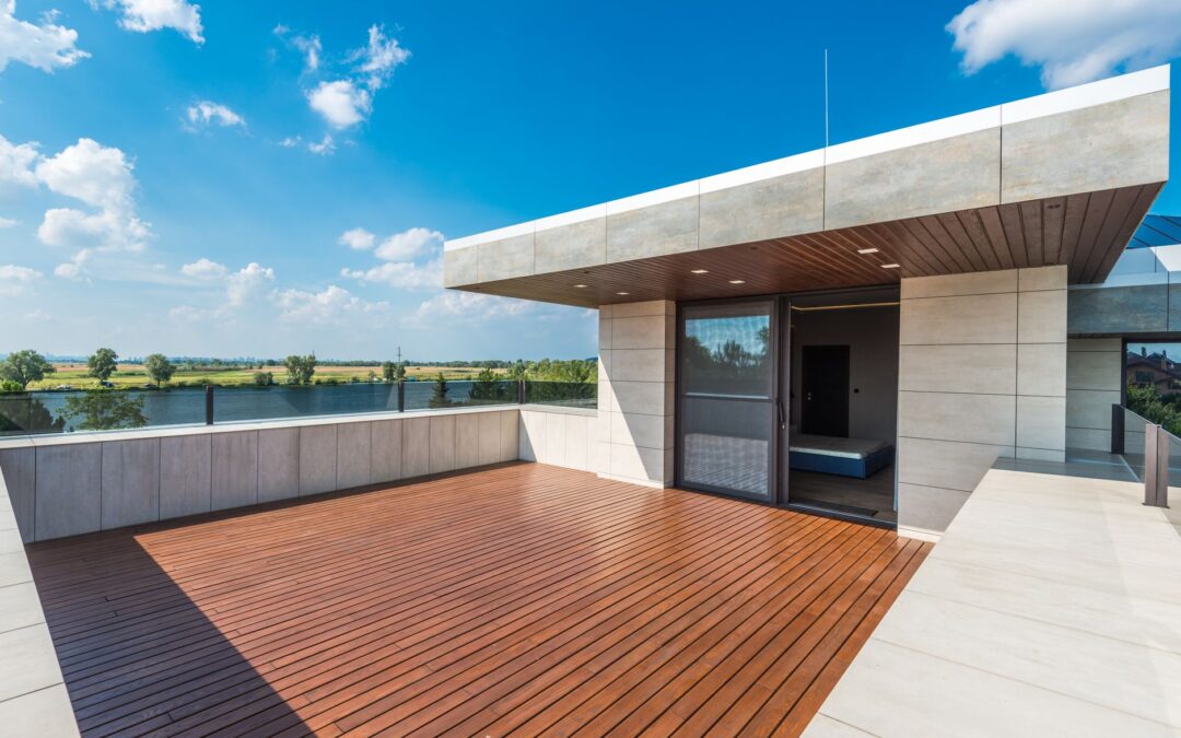 Spacious rooftop terrace offering a stunning view of the river and countryside under a bright blue sky.