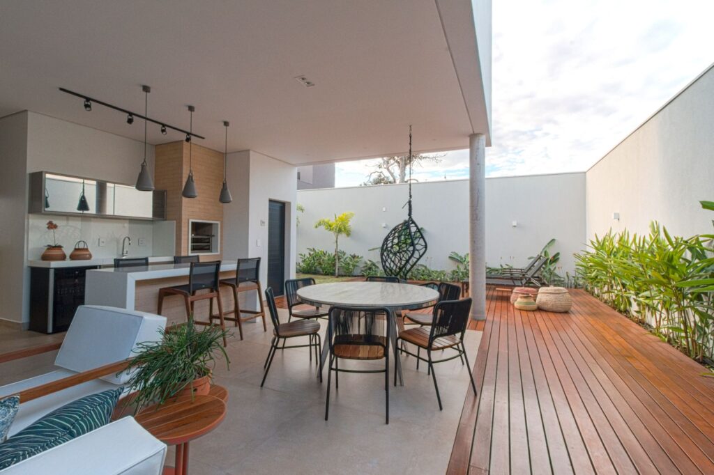 Stylish open patio with dining set, kitchen, and outdoor decor, perfect for relaxation.