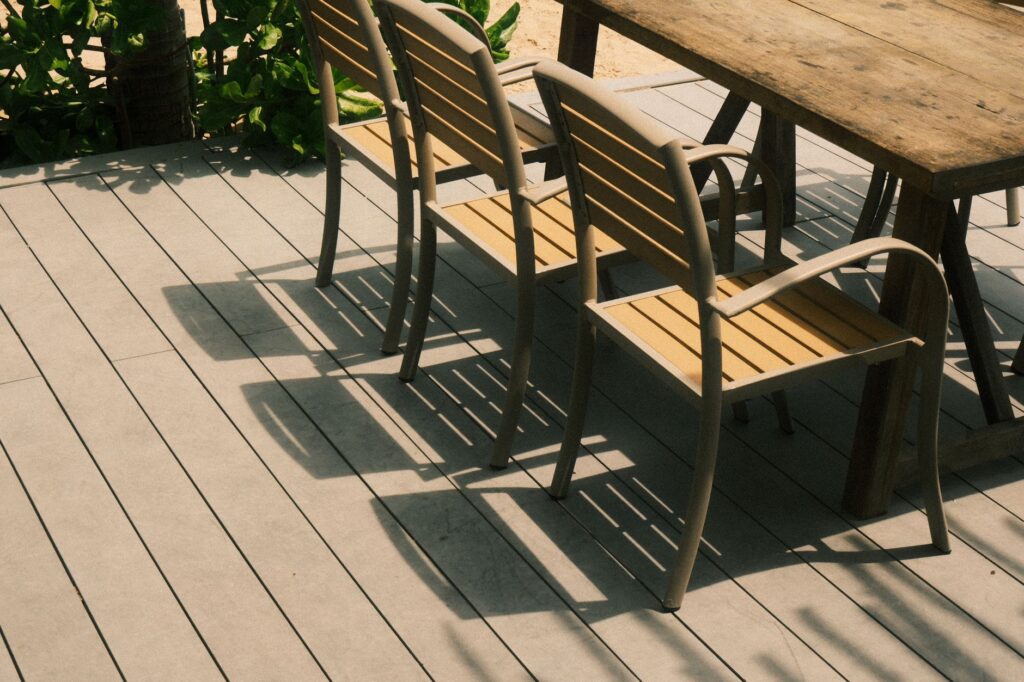 Stylish outdoor patio chairs and table set on a sunny deck in Phan Thiet, Vietnam.